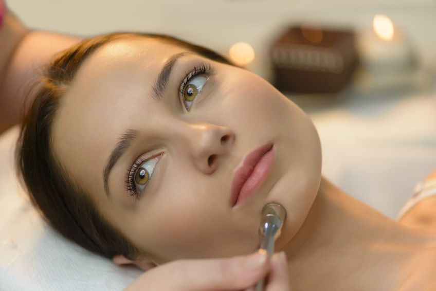 Beautiful woman getting microdermabrasion at beauty salon