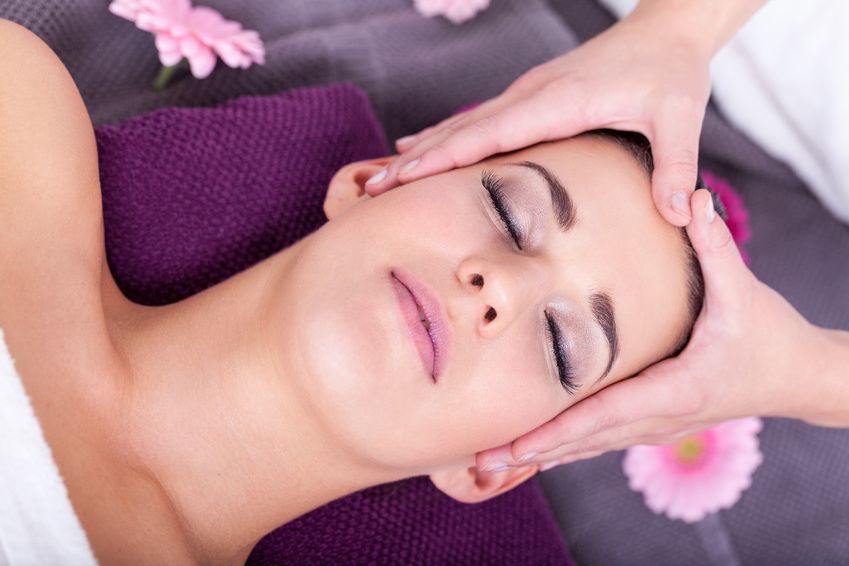 entspannte junge frau bei einer gesichts kopf massage wellness spa gesundheit enstpannung